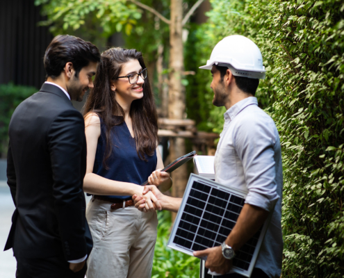 Electrician Shaking Hands With Business Owners